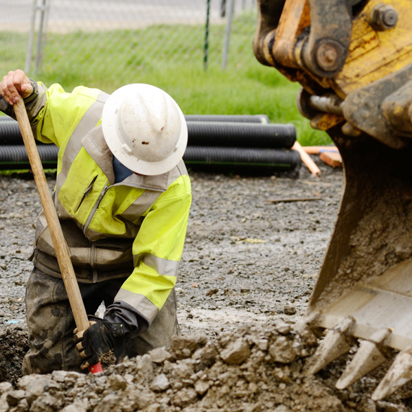 Workers leveling fresh concrete at site