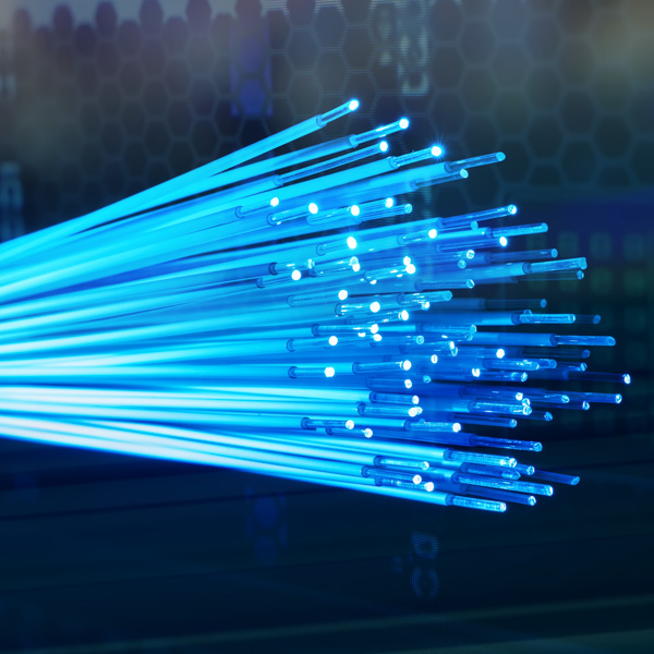 Blue fiber optic cables glowing in the dark